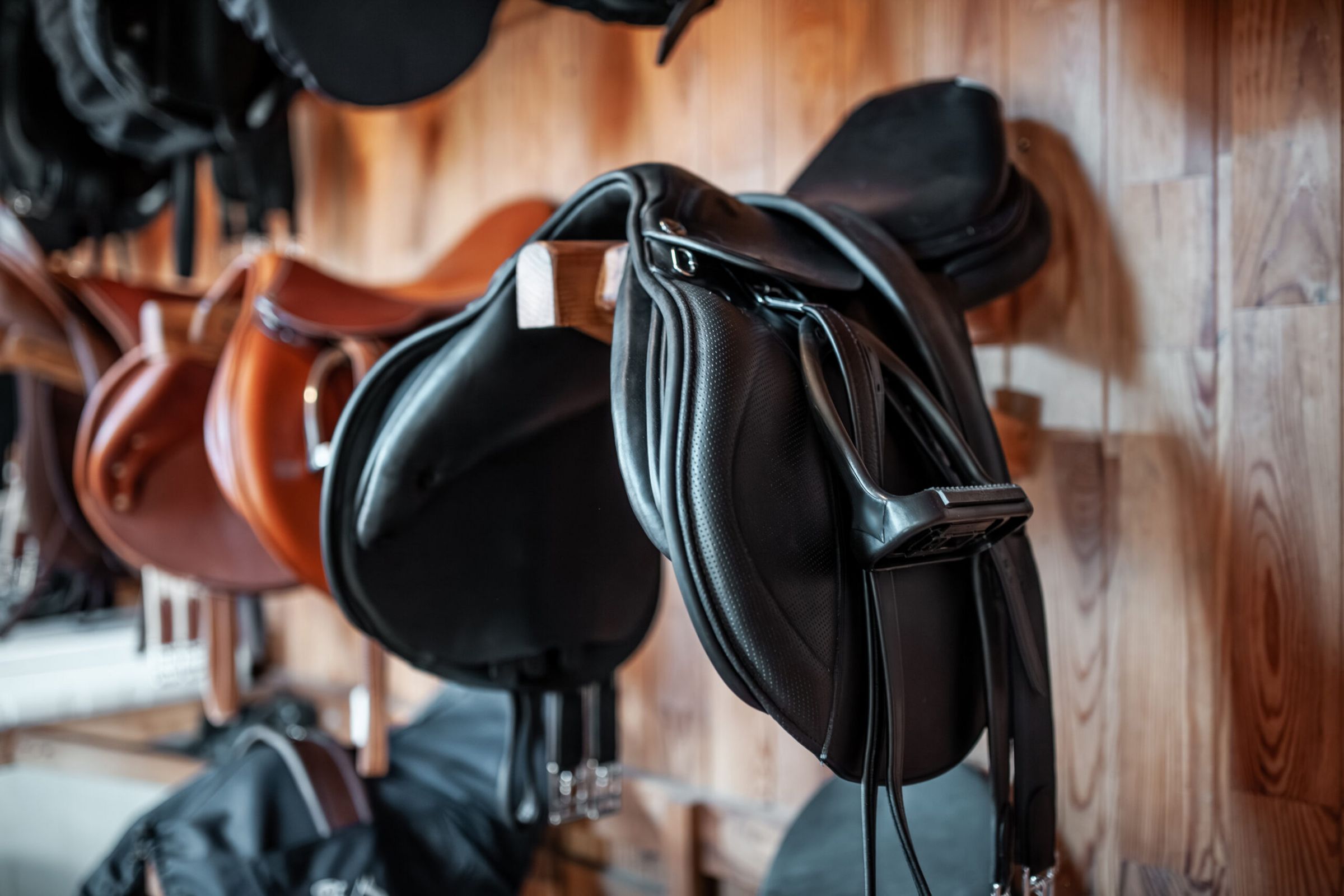 Ryder at Willow Brook Glass vase on black marble table with cut orchid and white curtain